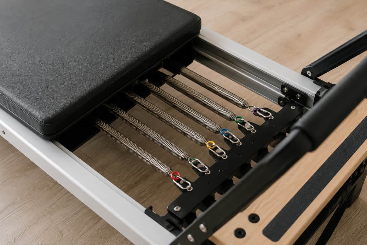 Close up of pilates reformer springs and carriage showing spring resistance system